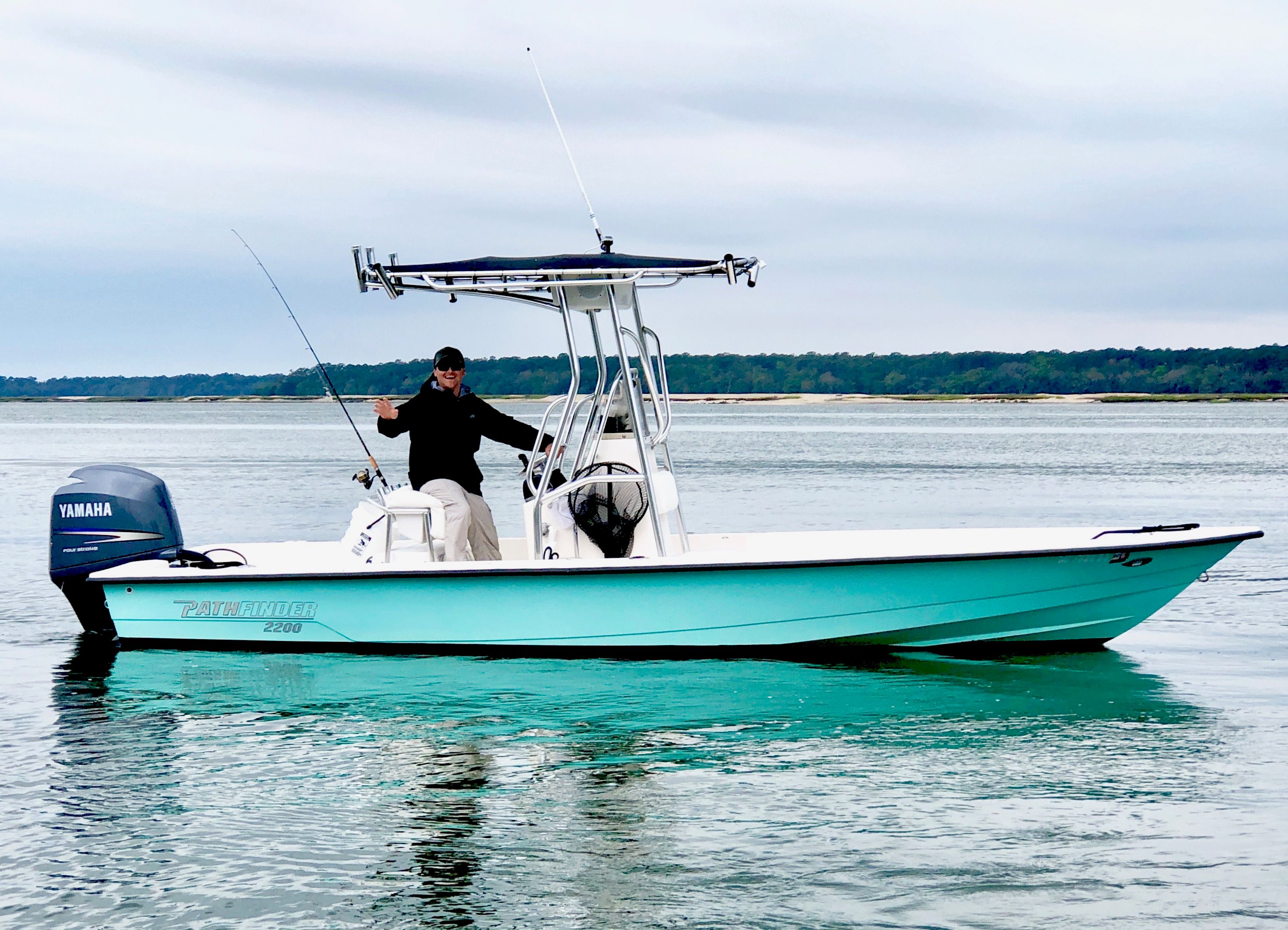 Captain Campbell running the 22-foot Pathfinder with T-top across calm water
