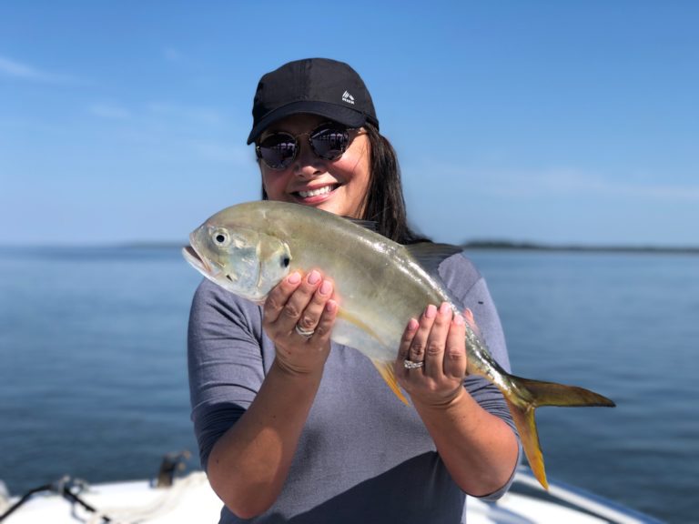 Smiling angler holding her catch on Hilton Head waters