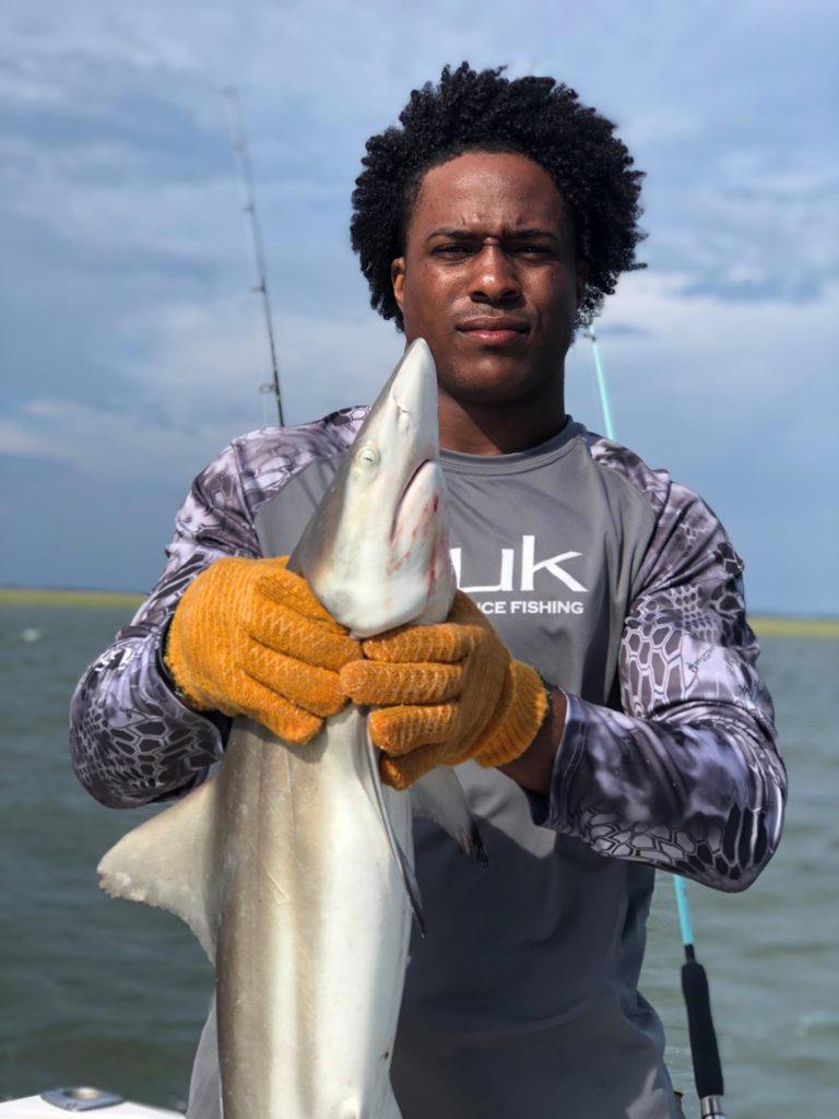 Angler holding a shark caught in the Hilton Head marsh