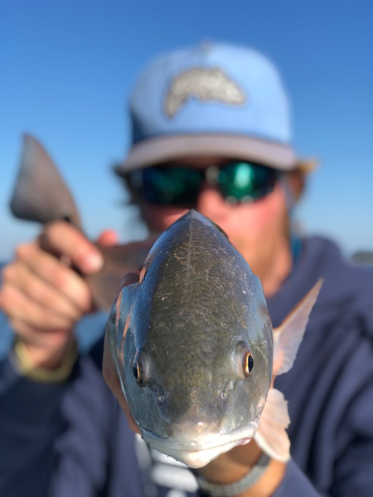 Close-up of an angler holding a fish
