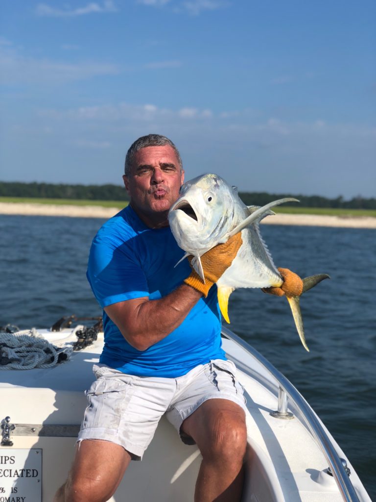 Angler holding a jack crevalle on the bow